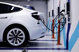 High power EV chargers at a brightly lit freeway hub near Houston